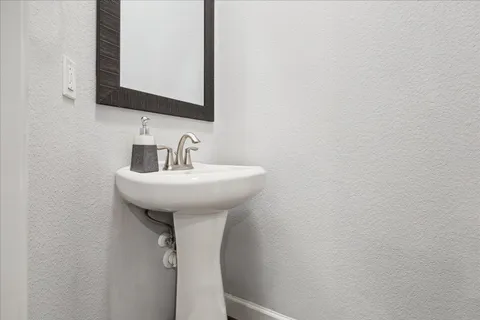 a view of a hallway with wooden floor and entryway