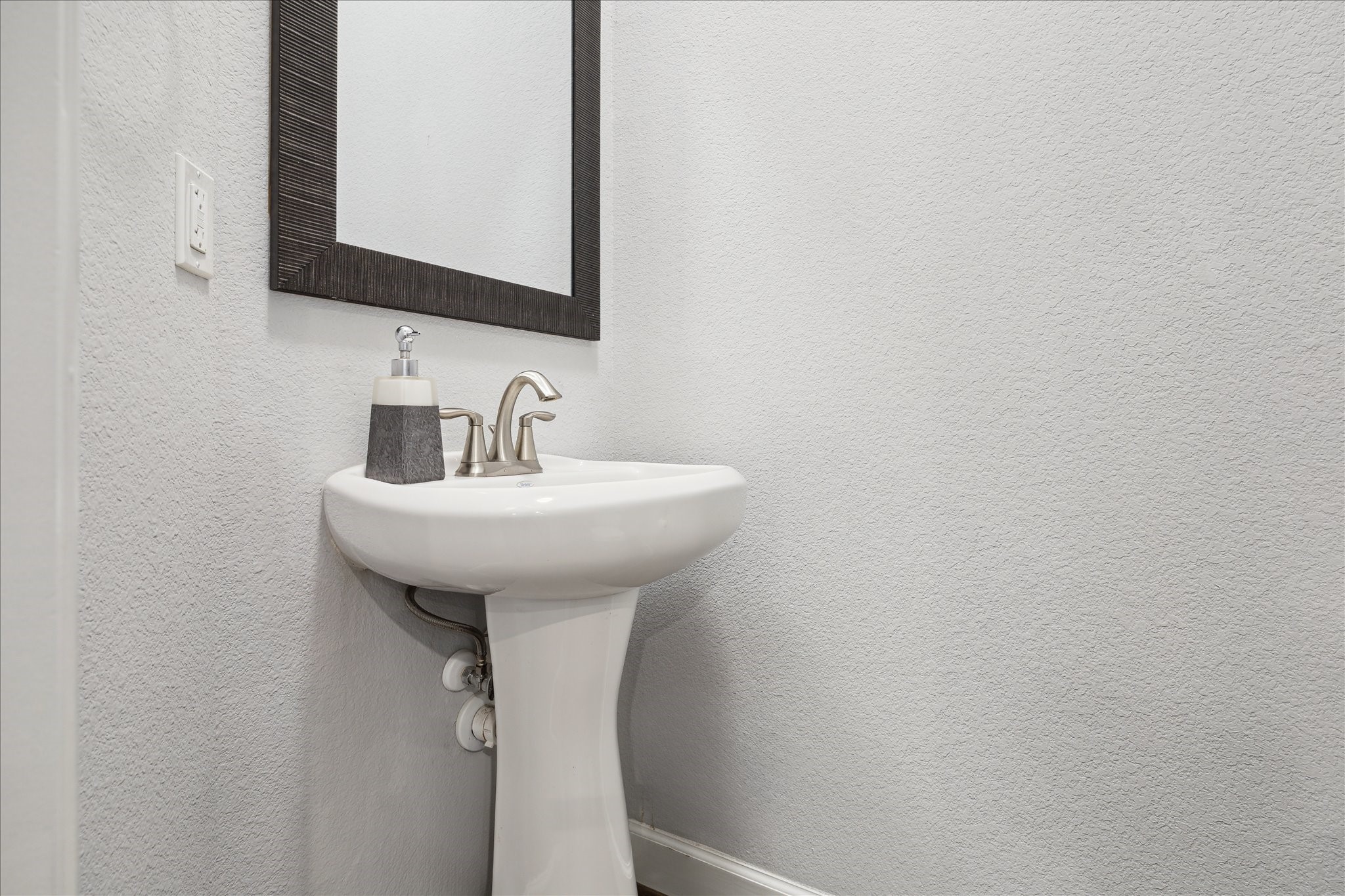 2430 Sheridan Street Houston, TX 77030 - Photo 10 of 28 a bathroom with a sink and a mirror