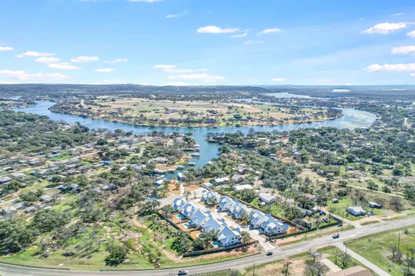 an aerial view of residential houses with city view