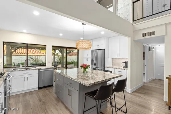 a spacious bedroom with a bed and a lamp