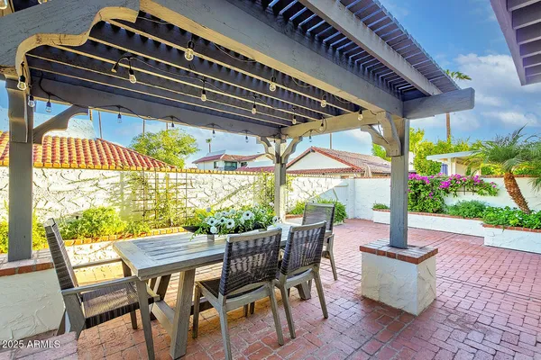 a view of a patio with a table chairs and a patio