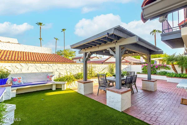 a view of a patio with a table chairs and a potted plants