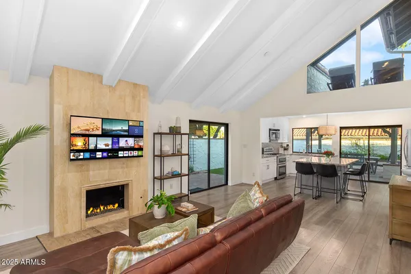 a living room with furniture and wooden floor