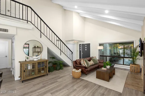 a living room with furniture and a wooden floor