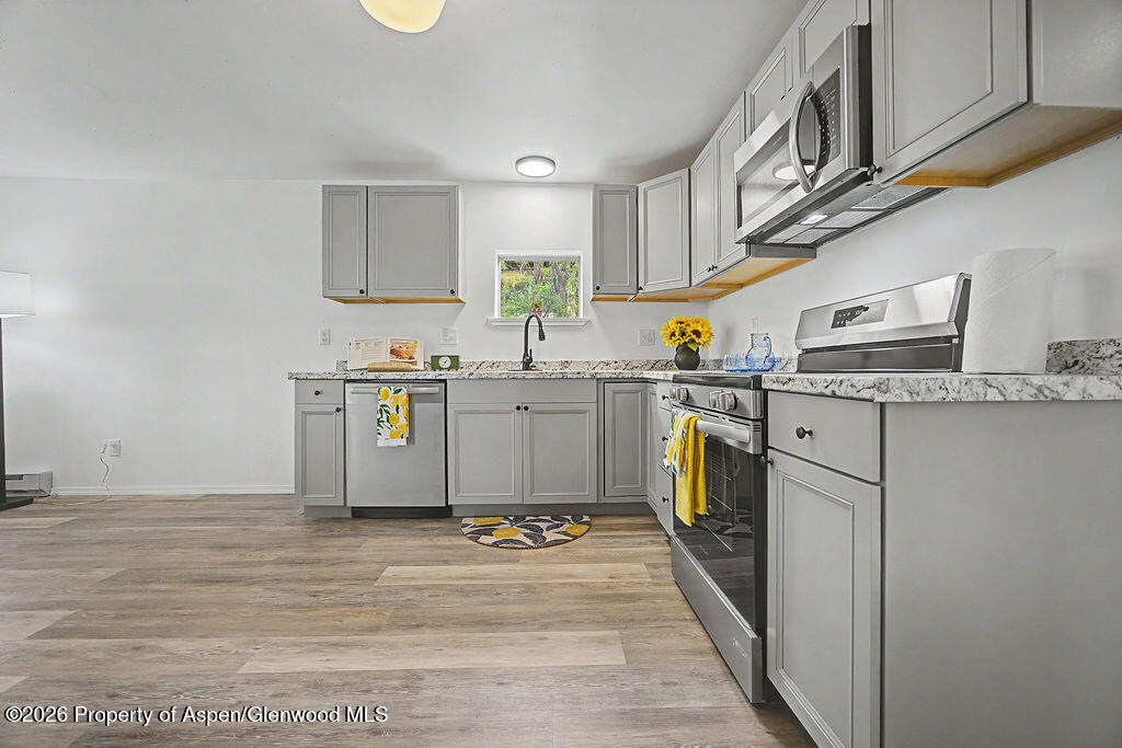 54 South Ranney Street Craig, CO 81625 - Photo 4 of 32 a kitchen with stainless steel appliances granite countertop a sink and cabinets