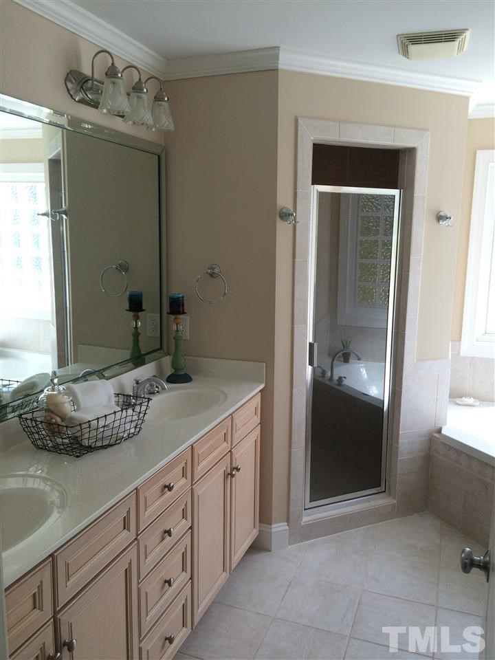 537 Pace Street Raleigh, NC 27604 - Photo 18 of 25 a bathroom with a granite countertop sink and a mirror