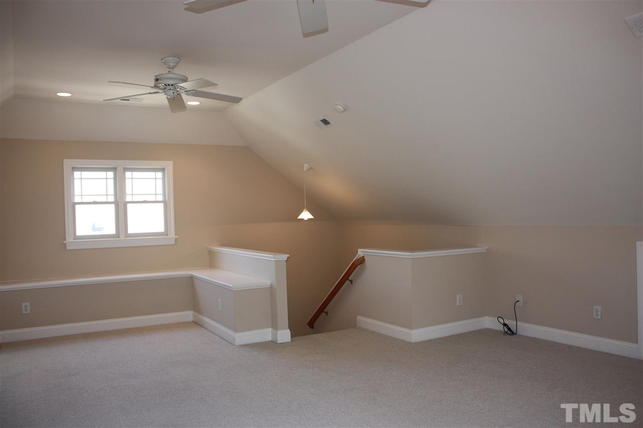 537 Pace Street Raleigh, NC 27604 - Photo 22 of 25 an empty room with chandelier fan and windows