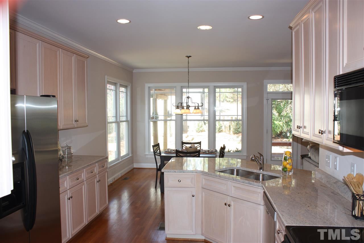 537 Pace Street Raleigh, NC 27604 - Photo 6 of 25 a kitchen with stainless steel appliances granite countertop a sink a stove and a refrigerator