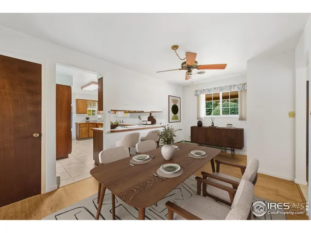 a living room with furniture kitchen view and a window