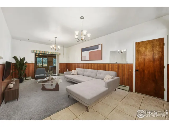 a living room with furniture a chandelier and a dining table
