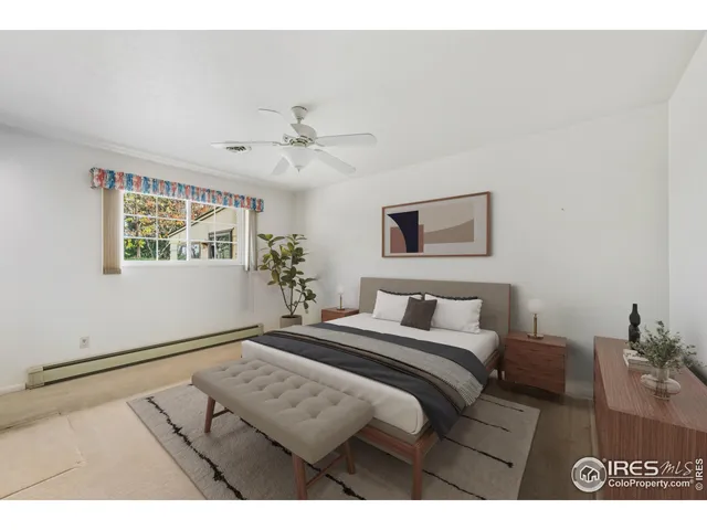 a bedroom with a bed mirror and a window