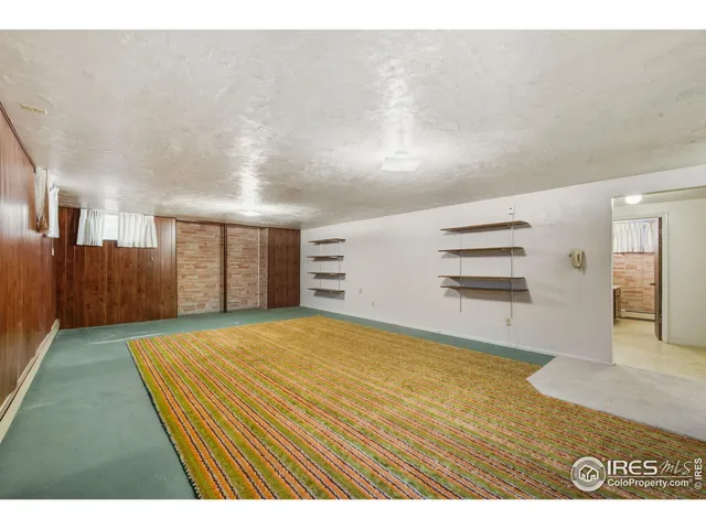 a view of an empty room with a fireplace