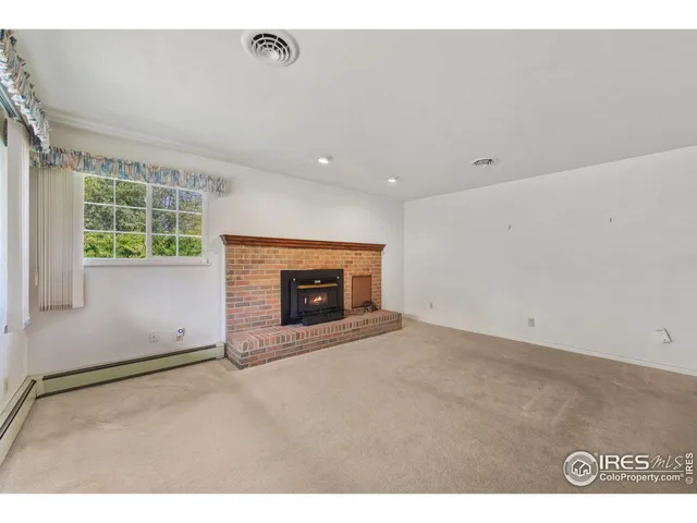 a view of empty room with a fireplace