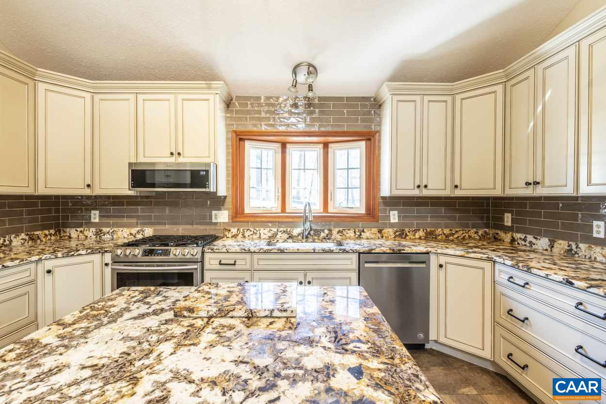 73 Amethyst Road Palmyra, VA 22963 - Photo 23 of 56 a kitchen with stainless steel appliances kitchen island granite countertop a sink and cabinets