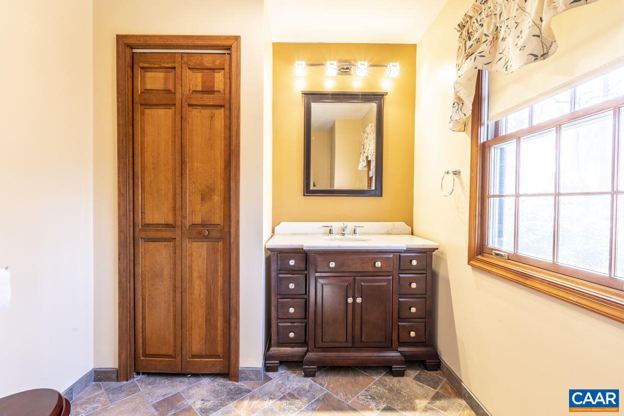 73 Amethyst Road Palmyra, VA 22963 - Photo 32 of 56 a bathroom with a sink a vanity and a mirror