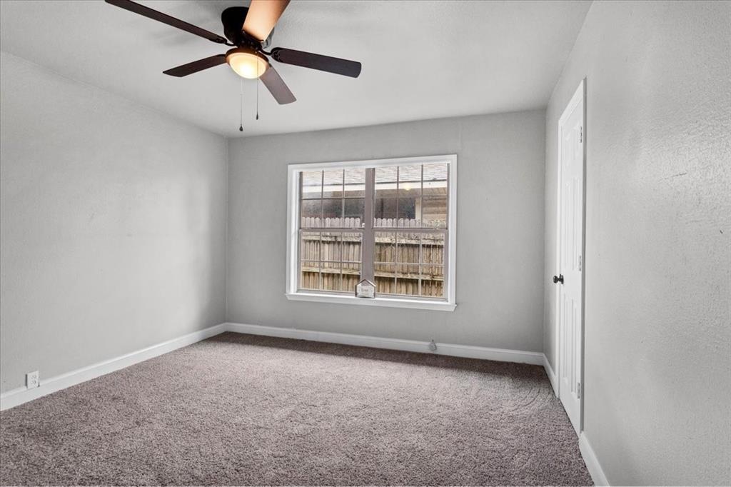736 Bullock Street Denison, TX 75020 - Photo 11 of 21 an empty room with a window and a fan