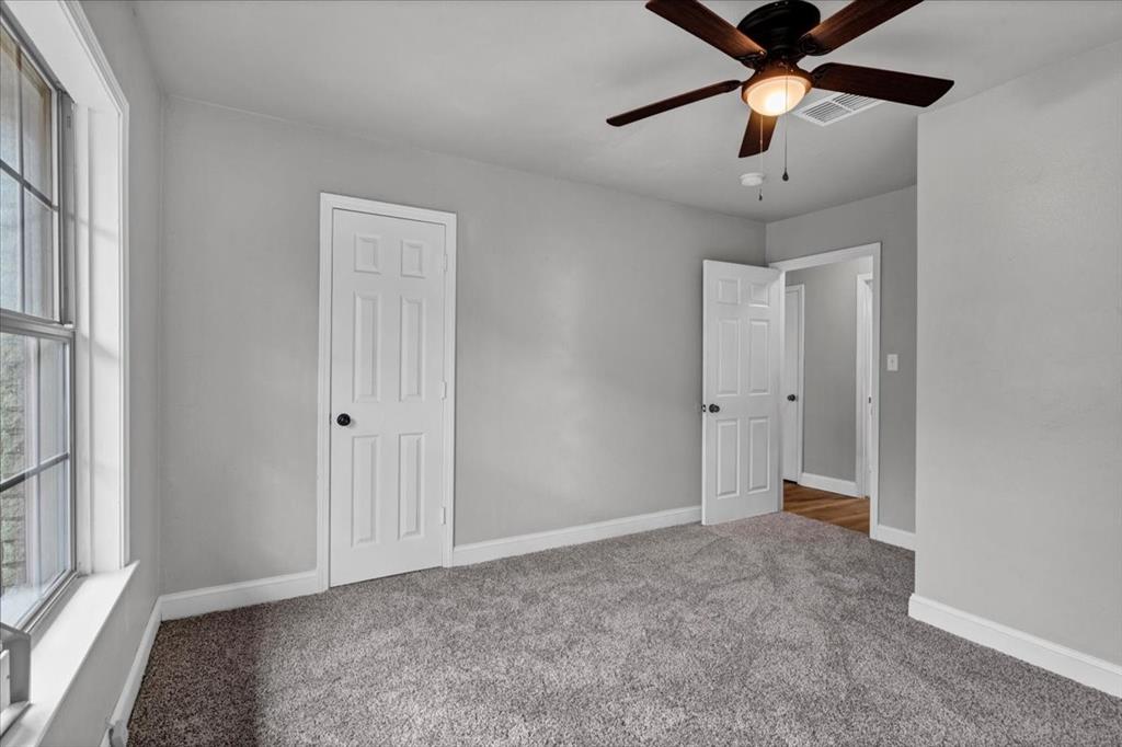 736 Bullock Street Denison, TX 75020 - Photo 12 of 21 wooden floor in an empty room with a window