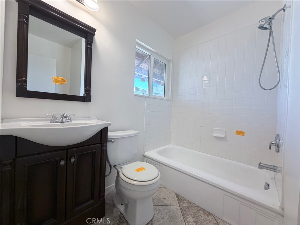 14808 Aztec Street Sylmar, CA 91342 - Photo 11 of 23 a bathroom with a toilet sink and mirror