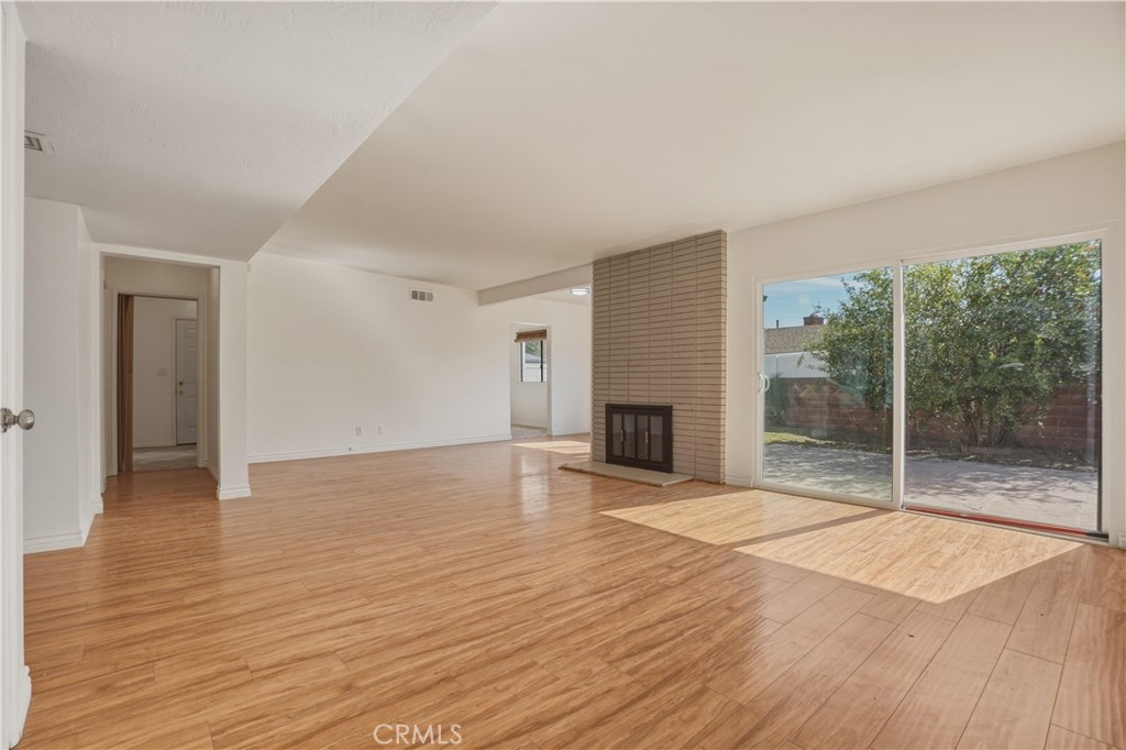 14808 Aztec Street Sylmar, CA 91342 - Photo 4 of 23 a view of empty room with wooden floor and fireplace