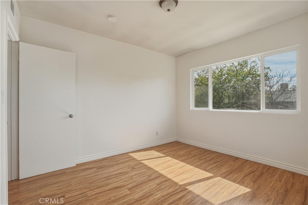 14808 Aztec Street Sylmar, CA 91342 - Photo 5 of 23 a view of empty room with wooden floor and fan