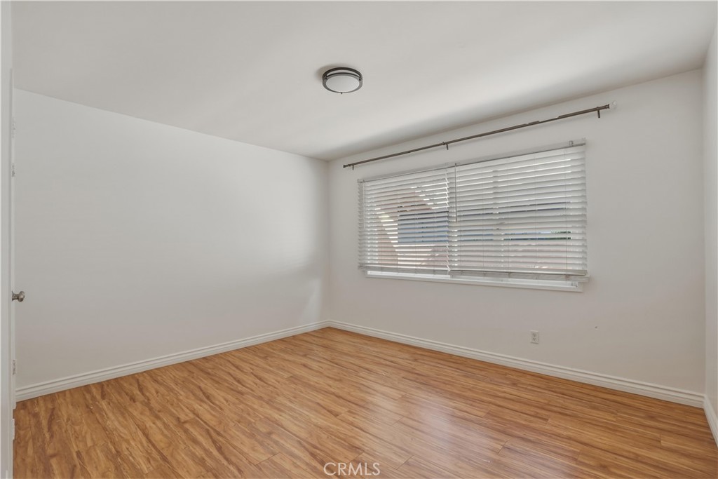 14808 Aztec Street Sylmar, CA 91342 - Photo 6 of 23 wooden floor in an empty room with a window