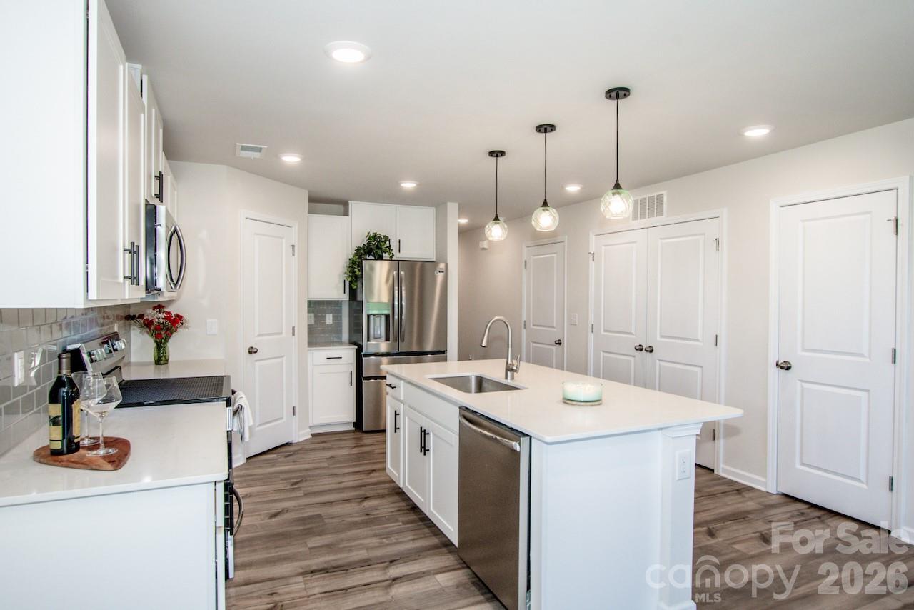 2742 Legacy Ridge Lane Catawba, NC 28609 - Photo 19 of 36 a kitchen with a sink stove and wooden floor