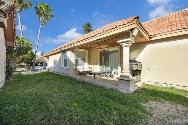 a view of a house with backyard and sitting area