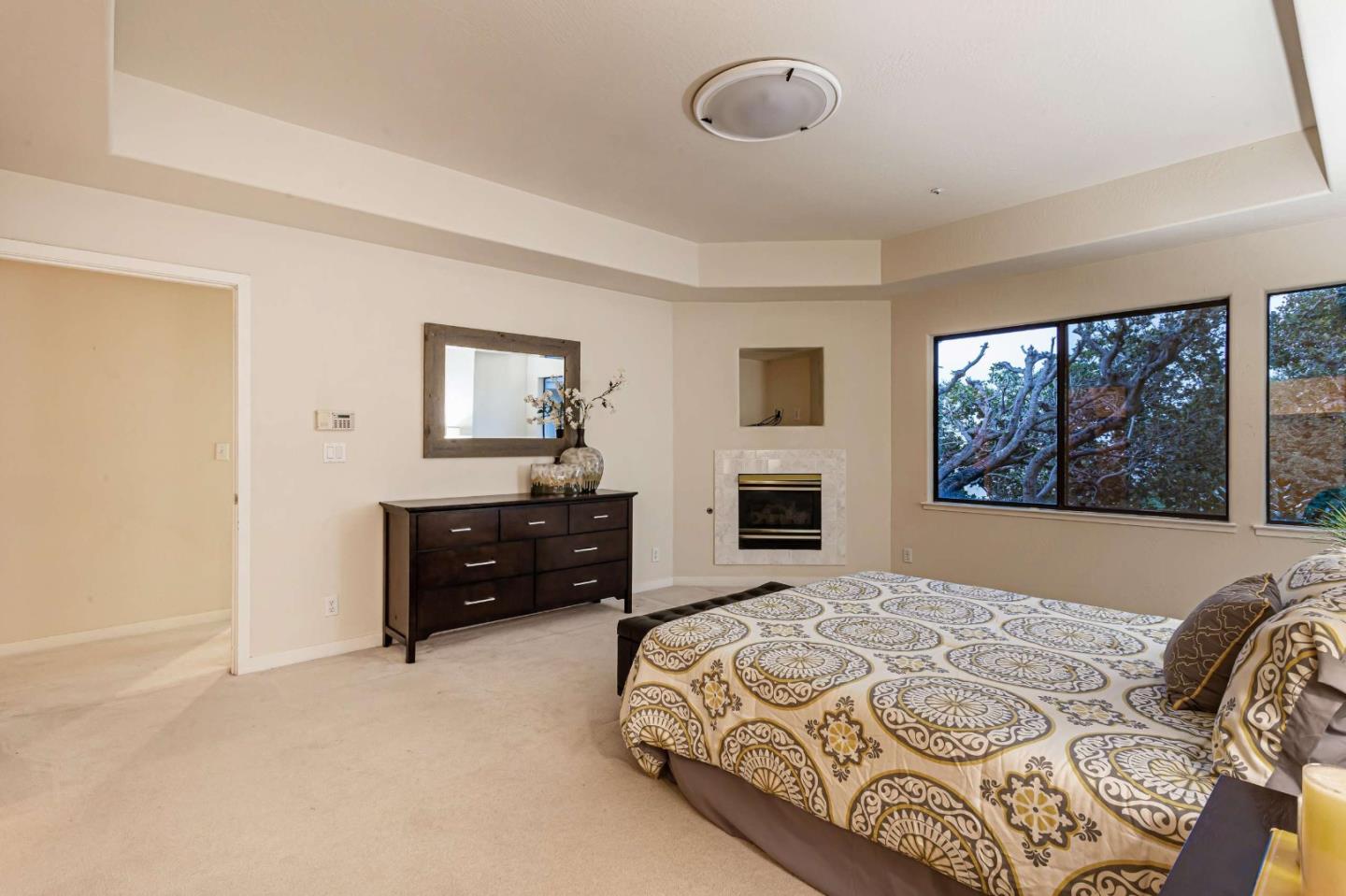 745 Holly Road Belmont, CA 94002 - Photo 26 of 50 a bedroom with a bed and a flat screen tv