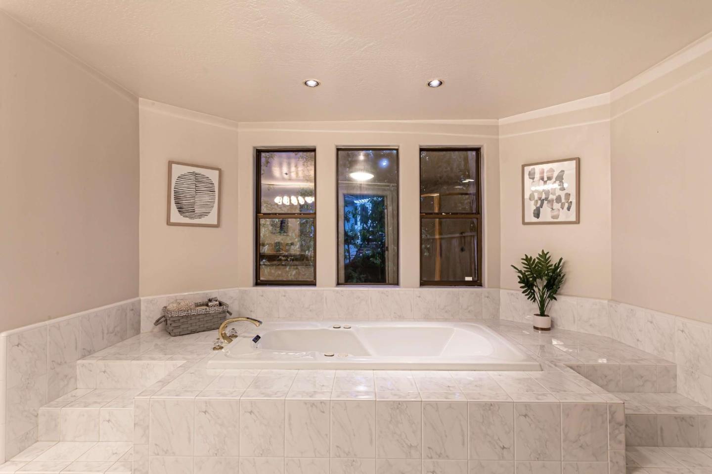 745 Holly Road Belmont, CA 94002 - Photo 28 of 50 a view of a spacious bathroom with a tub and mirror