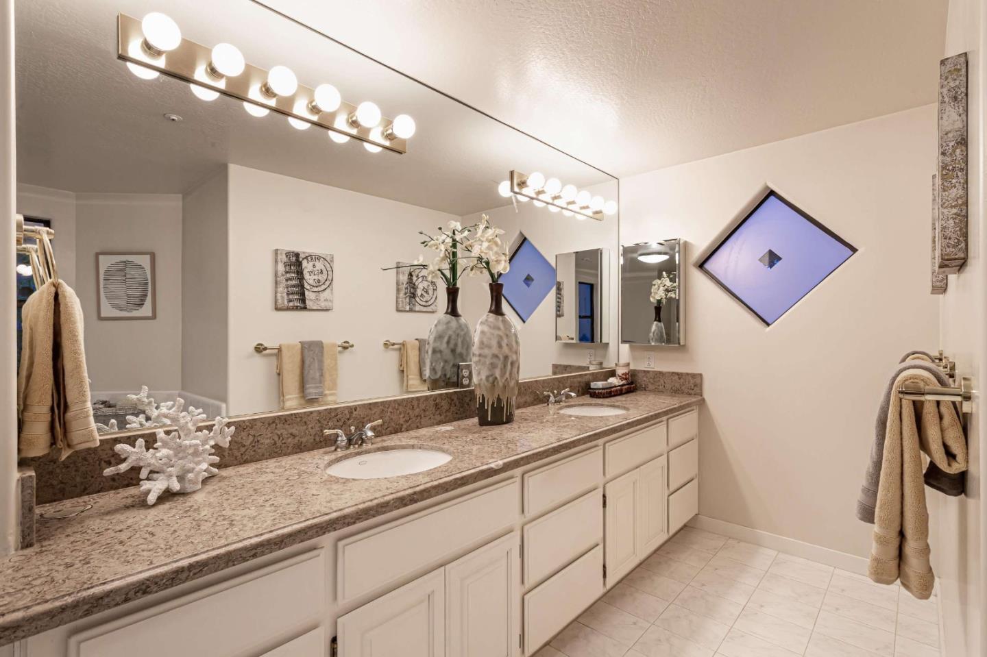 745 Holly Road Belmont, CA 94002 - Photo 29 of 50 a bathroom with double vanity sinks a vanity and a large mirror