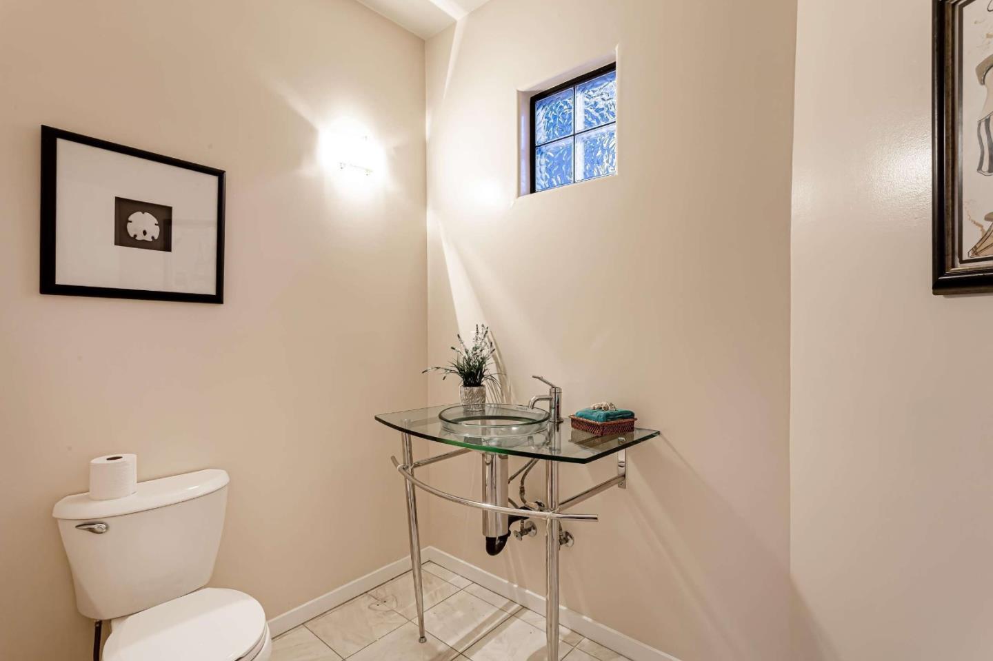 745 Holly Road Belmont, CA 94002 - Photo 33 of 50 a bathroom with a toilet a sink and mirror