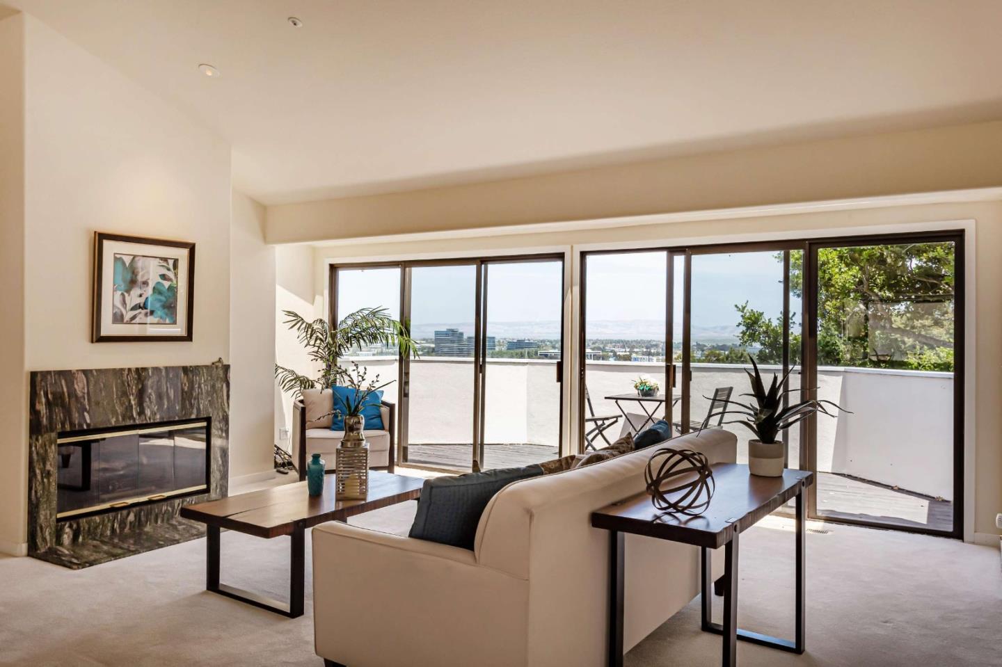 745 Holly Road Belmont, CA 94002 - Photo 7 of 50 a living room with furniture a large window and a flat screen tv