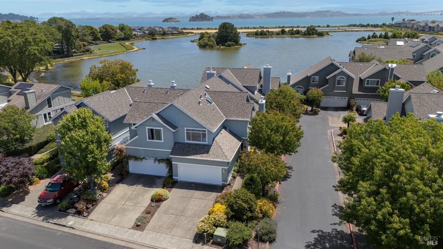 an aerial view of a house with outdoor space and lake view
