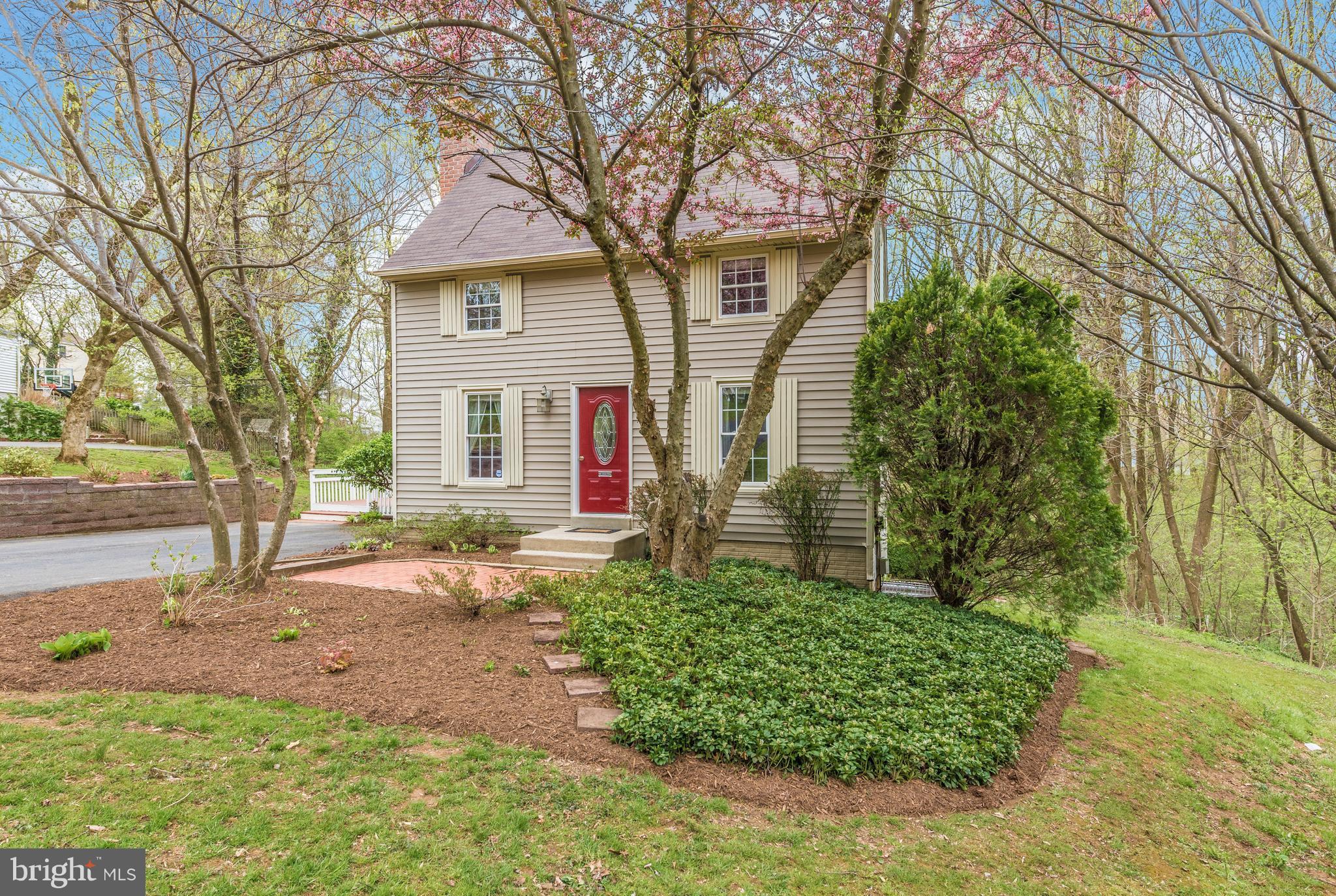 1706 Brookshire Run Point of Rocks, MD 21777 - Photo 2 of 29 a front view of a house with a garden and trees