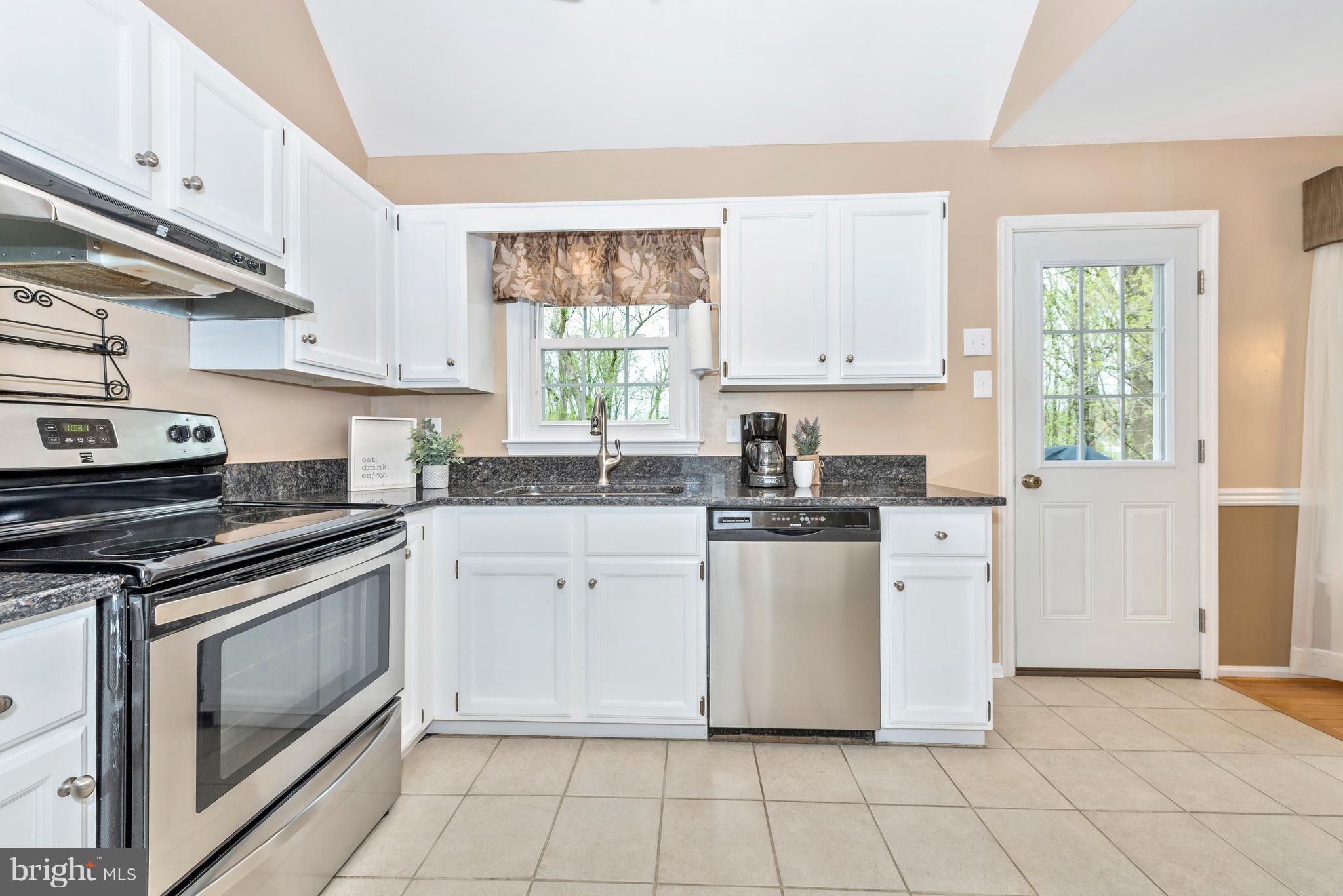 1706 Brookshire Run Point of Rocks, MD 21777 - Photo 10 of 29 a kitchen with granite countertop white cabinets white appliances a sink and a window