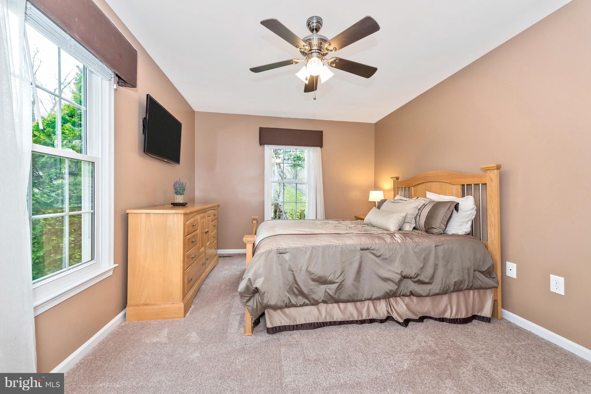 1706 Brookshire Run Point of Rocks, MD 21777 - Photo 13 of 29 a spacious bedroom with a bed flat screen tv and a large window