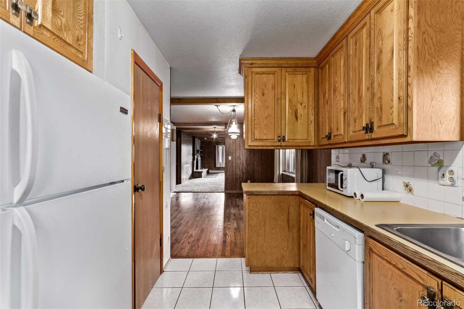 15481 Rist Canyon Road Bellvue, CO 80512 - Photo 15 of 50 a kitchen with a sink and a refrigerator