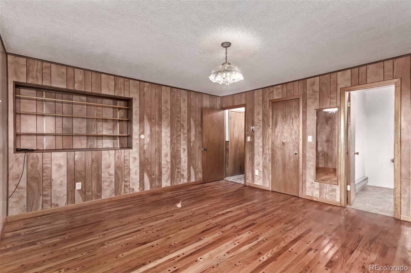 15481 Rist Canyon Road Bellvue, CO 80512 - Photo 18 of 50 a view of an empty room with wooden floor and a window