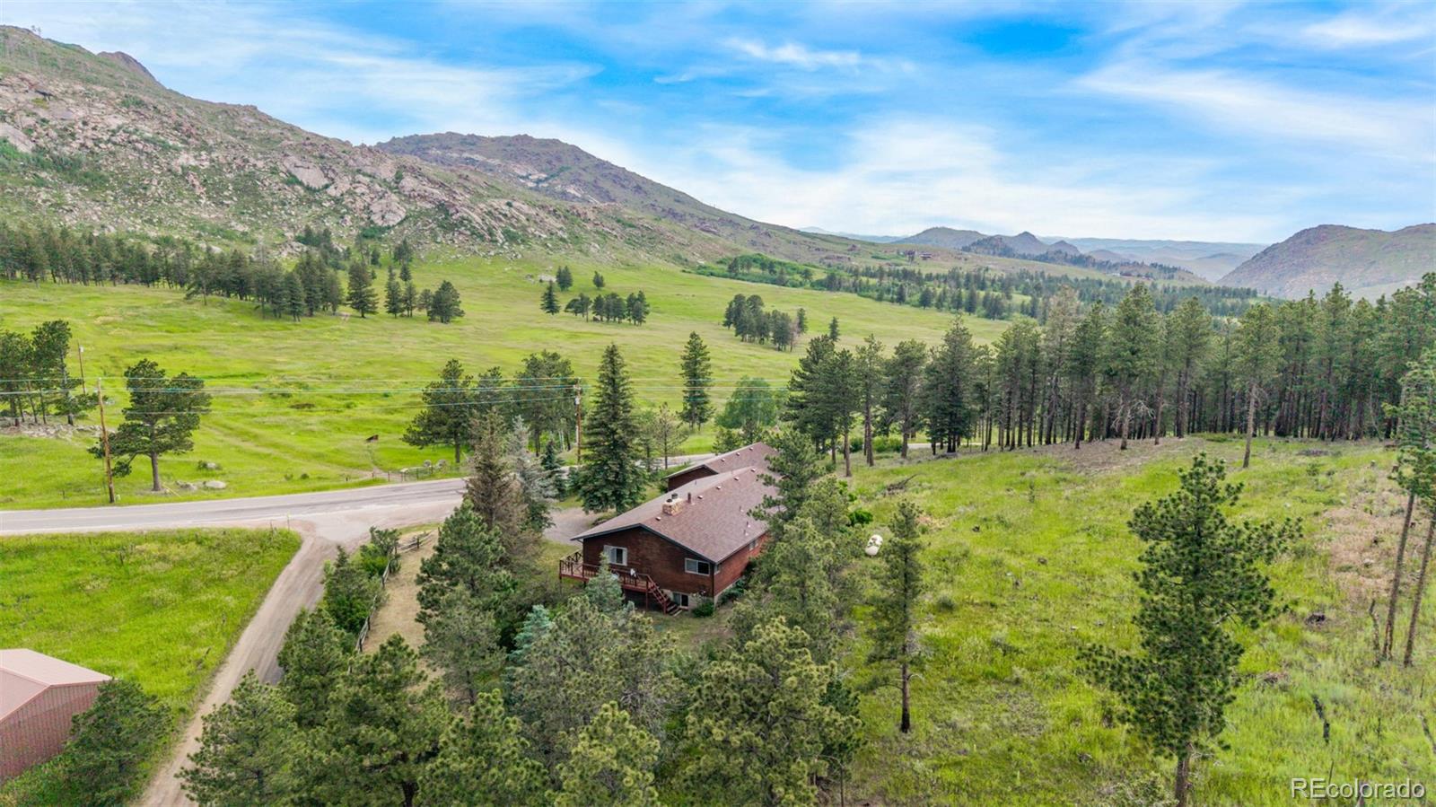 15481 Rist Canyon Road Bellvue, CO 80512 - Photo 39 of 50 a view of a lush green hillside and houses