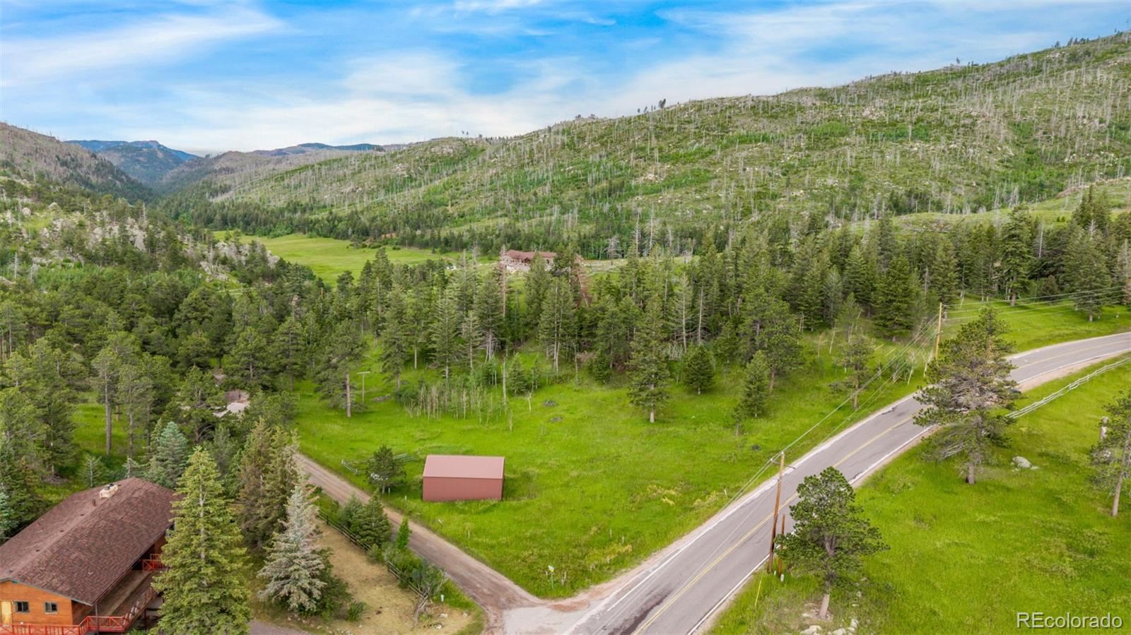 15481 Rist Canyon Road Bellvue, CO 80512 - Photo 41 of 50 a view of a city with lush green forest