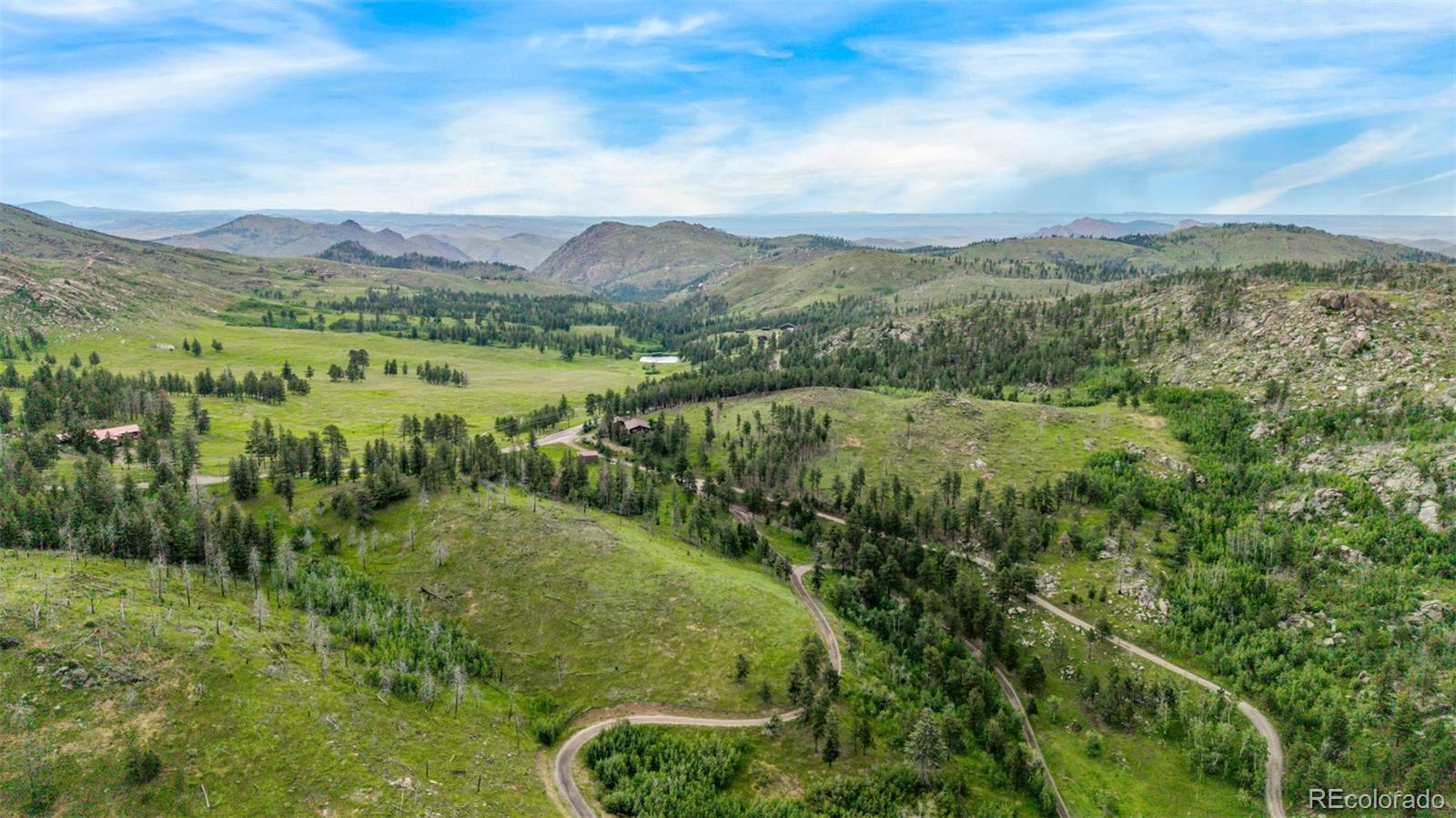 15481 Rist Canyon Road Bellvue, CO 80512 - Photo 46 of 50 a view of a lush green hillside and mountains