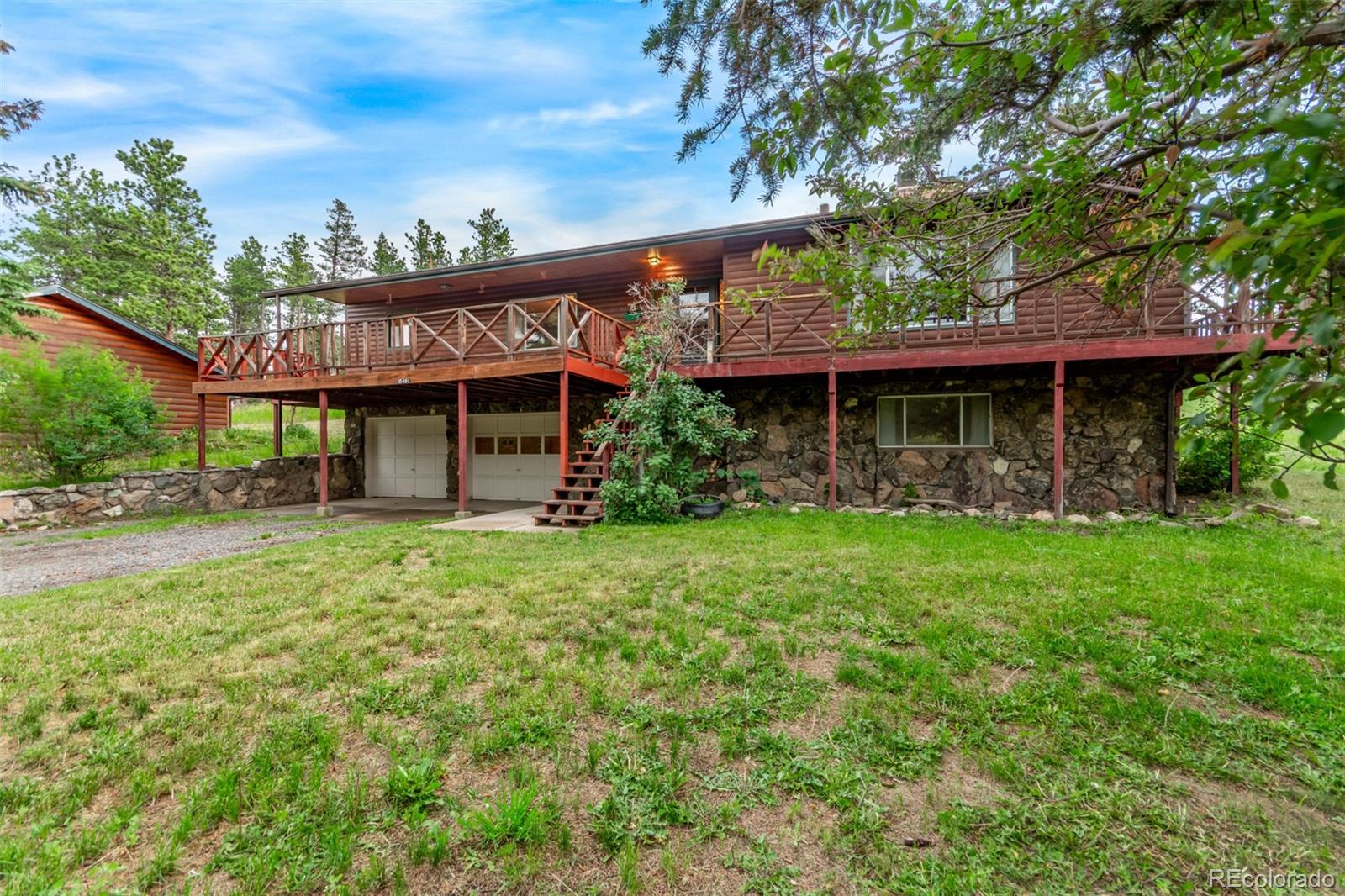 15481 Rist Canyon Road Bellvue, CO 80512 - Photo 5 of 50 a view of a house with a big yard plants and large trees
