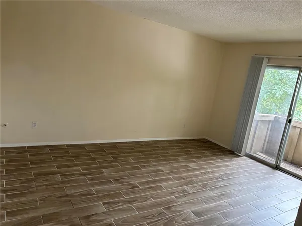a view of an empty room and wooden floor