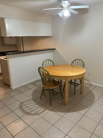 a dining room with furniture and chandelier