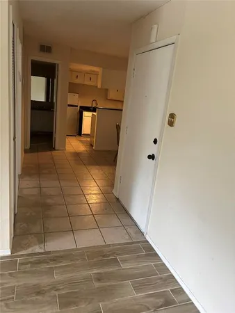a view of a livingroom with wooden floor and cabinet