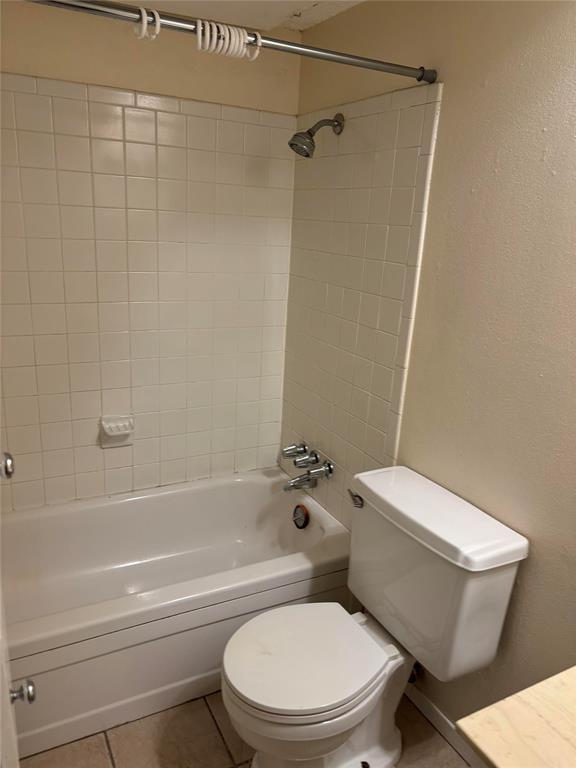 5921 Harvest Hill Road, Unit 2086 Dallas, TX 75230 - Photo 5 of 10 a white toilet and tub next to a bathroom