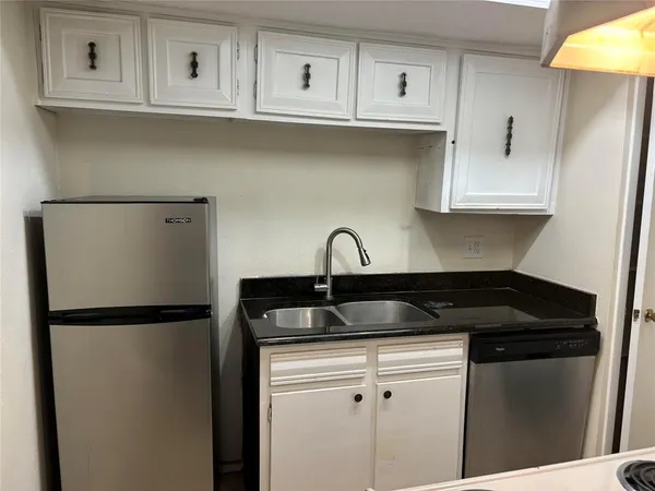 a close view of a sink and cabinets
