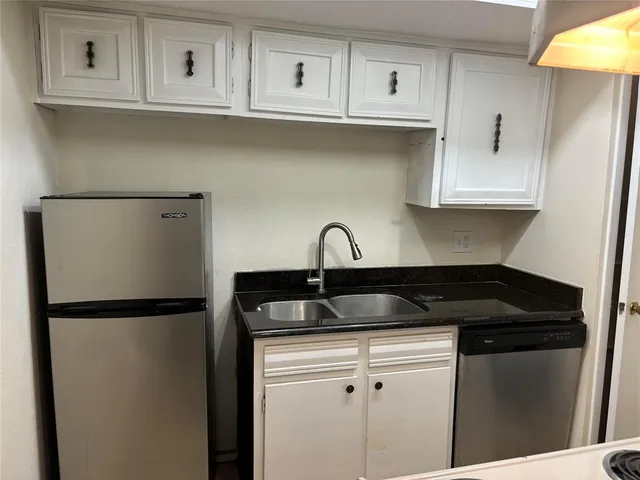 a close view of a sink and cabinets