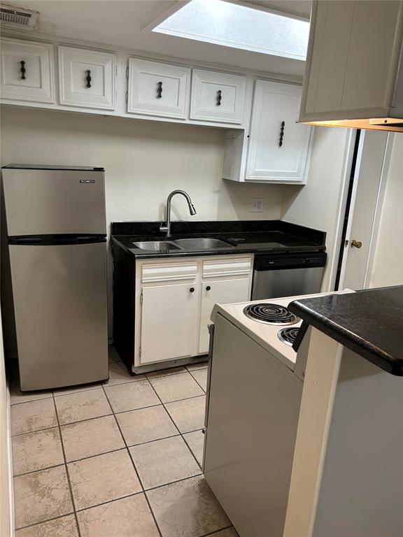 5921 Harvest Hill Road, Unit 2086 Dallas, TX 75230 - Photo 7 of 10 a kitchen with a sink a refrigerator and cabinets