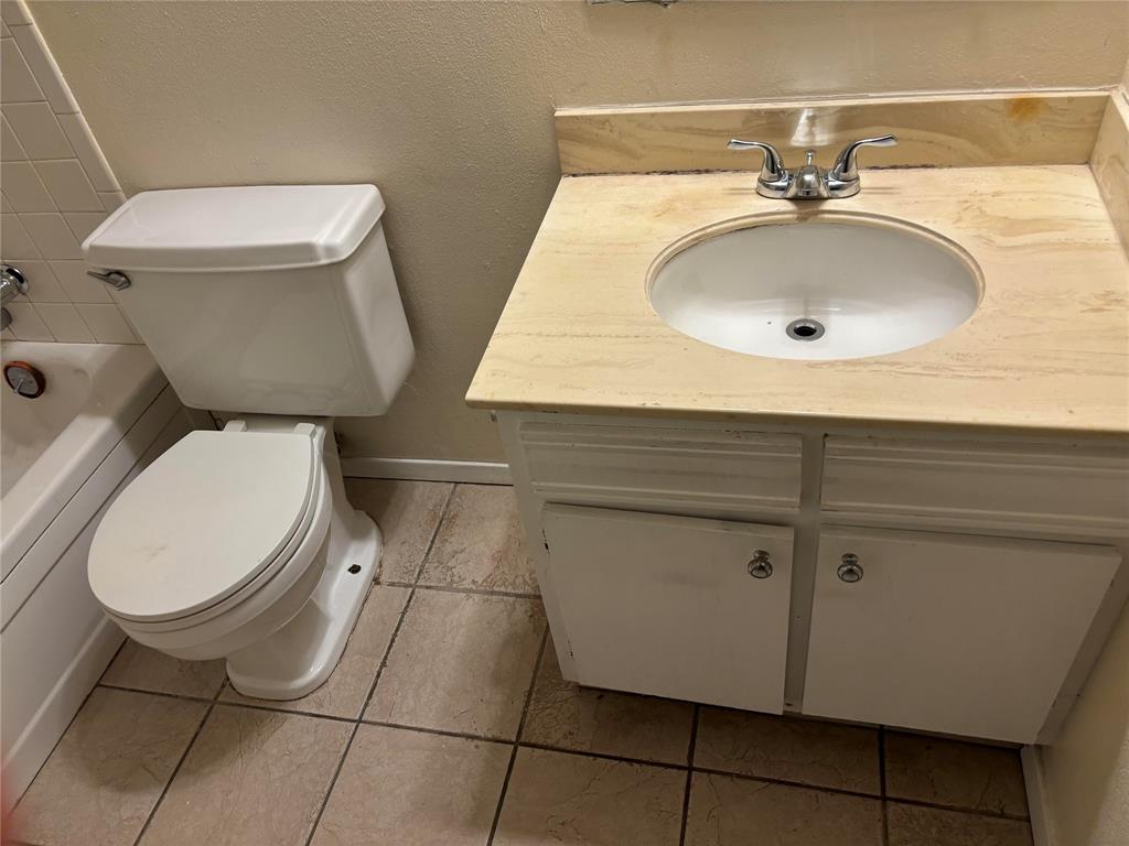 5921 Harvest Hill Road, Unit 2086 Dallas, TX 75230 - Photo 9 of 10 a bathroom with a toilet sink and mirror